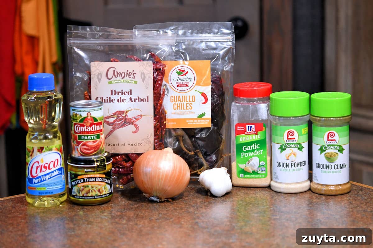 Authentic Guajillo Chile Sauce Recipe 3 ingredients for guajillo chile sauce on a countertop