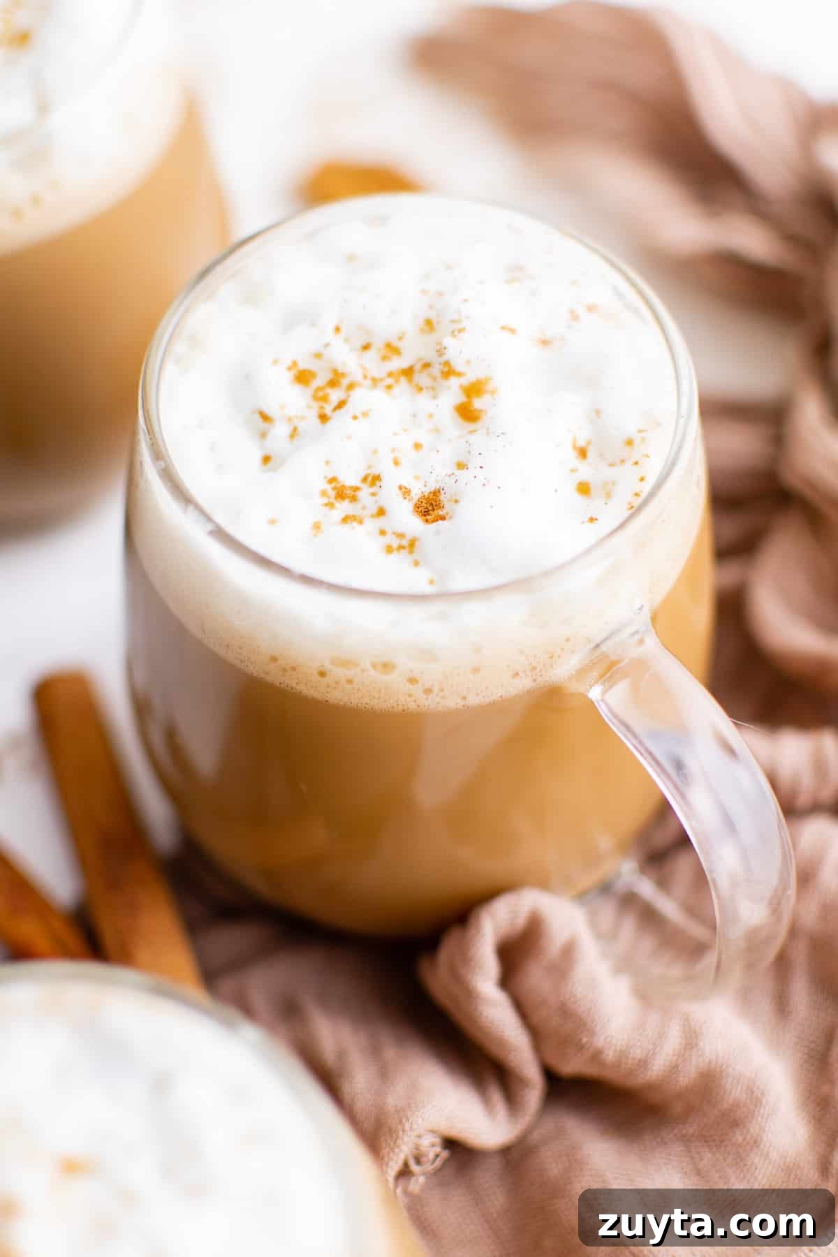 Top down view of a gingerbread latte in a glass mug.