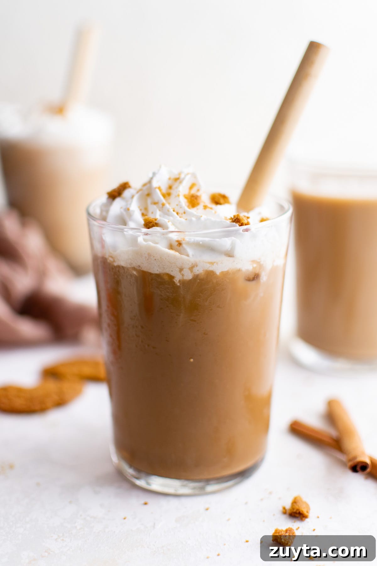 Cold gingerbread latte with a yellow straw.