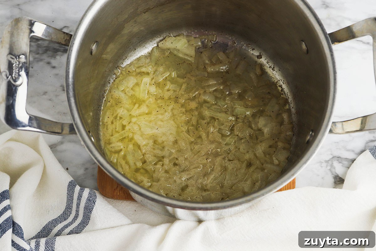 Creamy Cheesy Ham and Potato Casserole 6 Butter and onion in a saucepan.