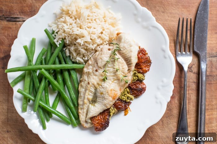 Sun-Dried Tomato Pesto Stuffed Chicken Breast Recipe 4 Sundried Tomato and Pesto Stuffed Chicken Breast on a white plate with basmati rice and green beans