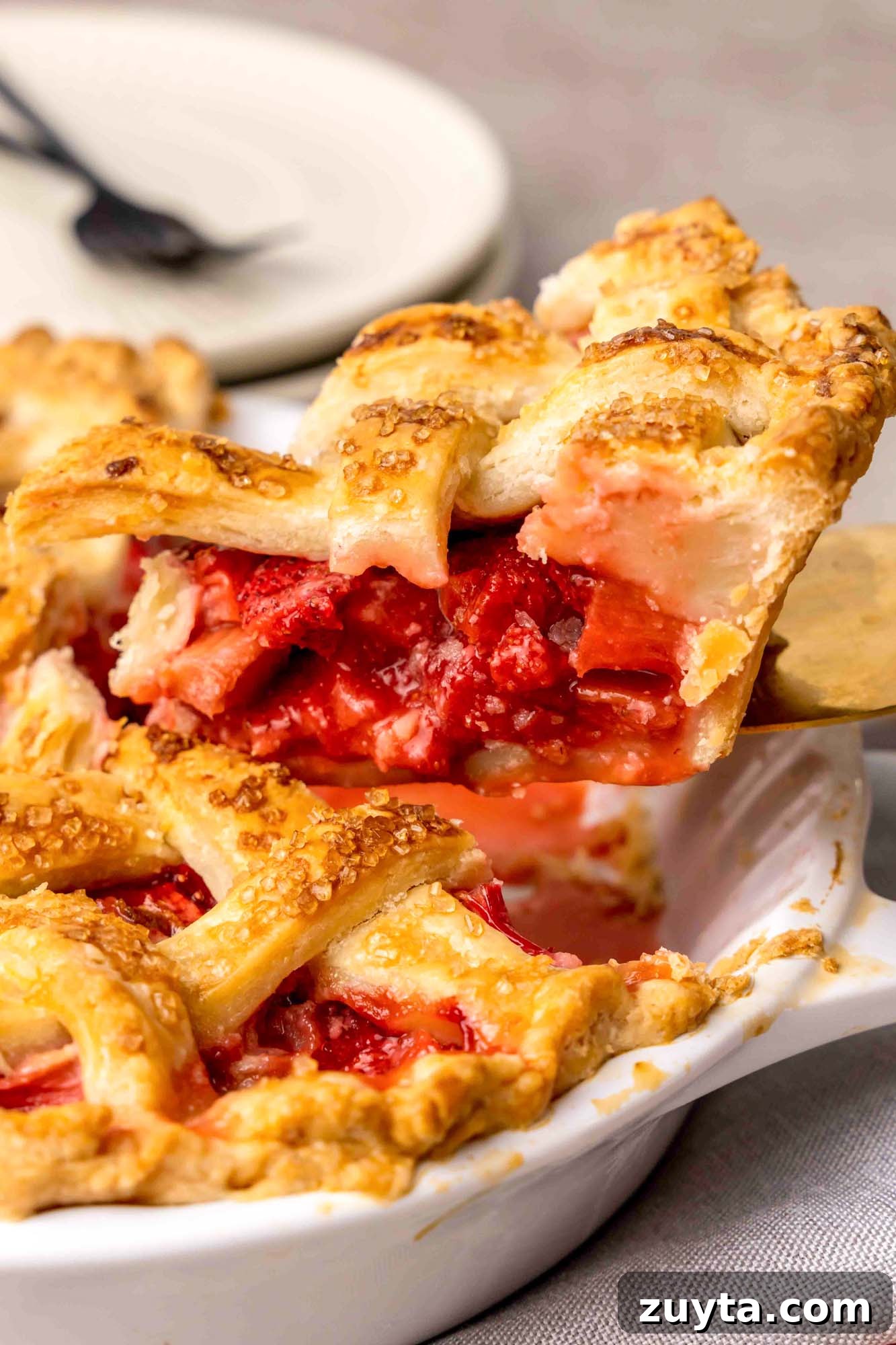 How to Make Strawberry Rhubarb Pie 6 Taking a slice of Strawberry Rhubarb Pie to serve