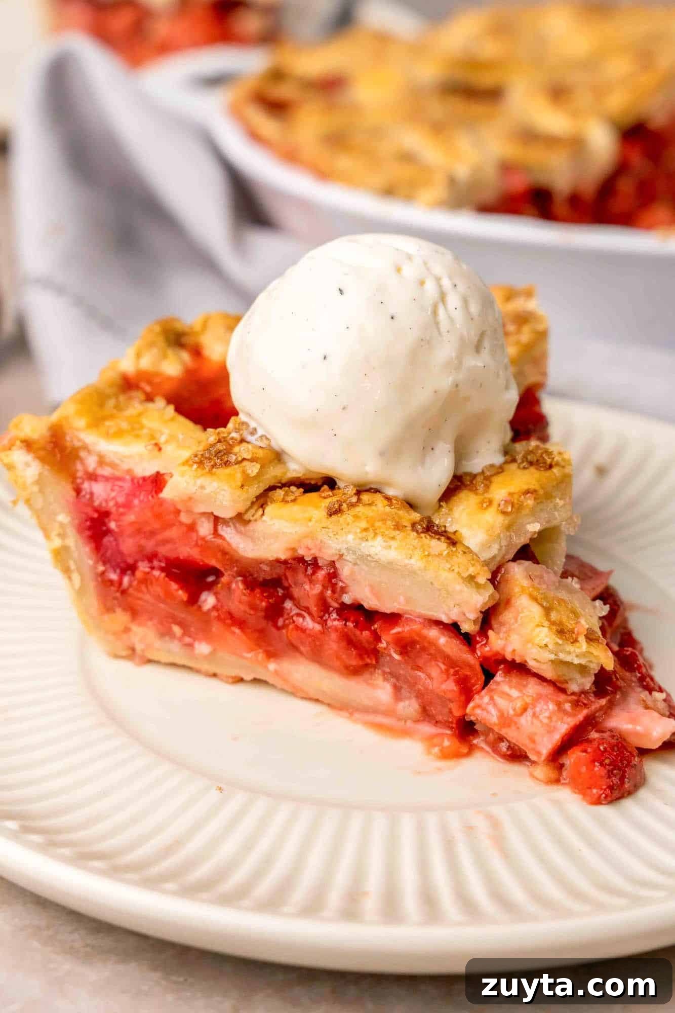 How to Make Strawberry Rhubarb Pie 7 A slice of the pie served with a scoop of vanilla ice cream