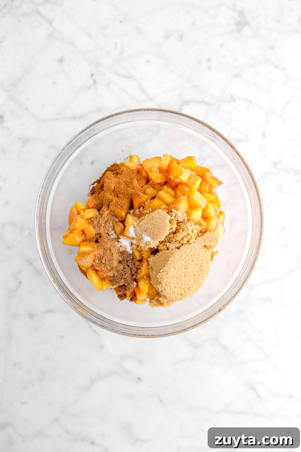 Cinnamon-Spiced Peach Hand Pies Recipe 8 brown sugar, chopped peaches, spices, and salt in glass bowl