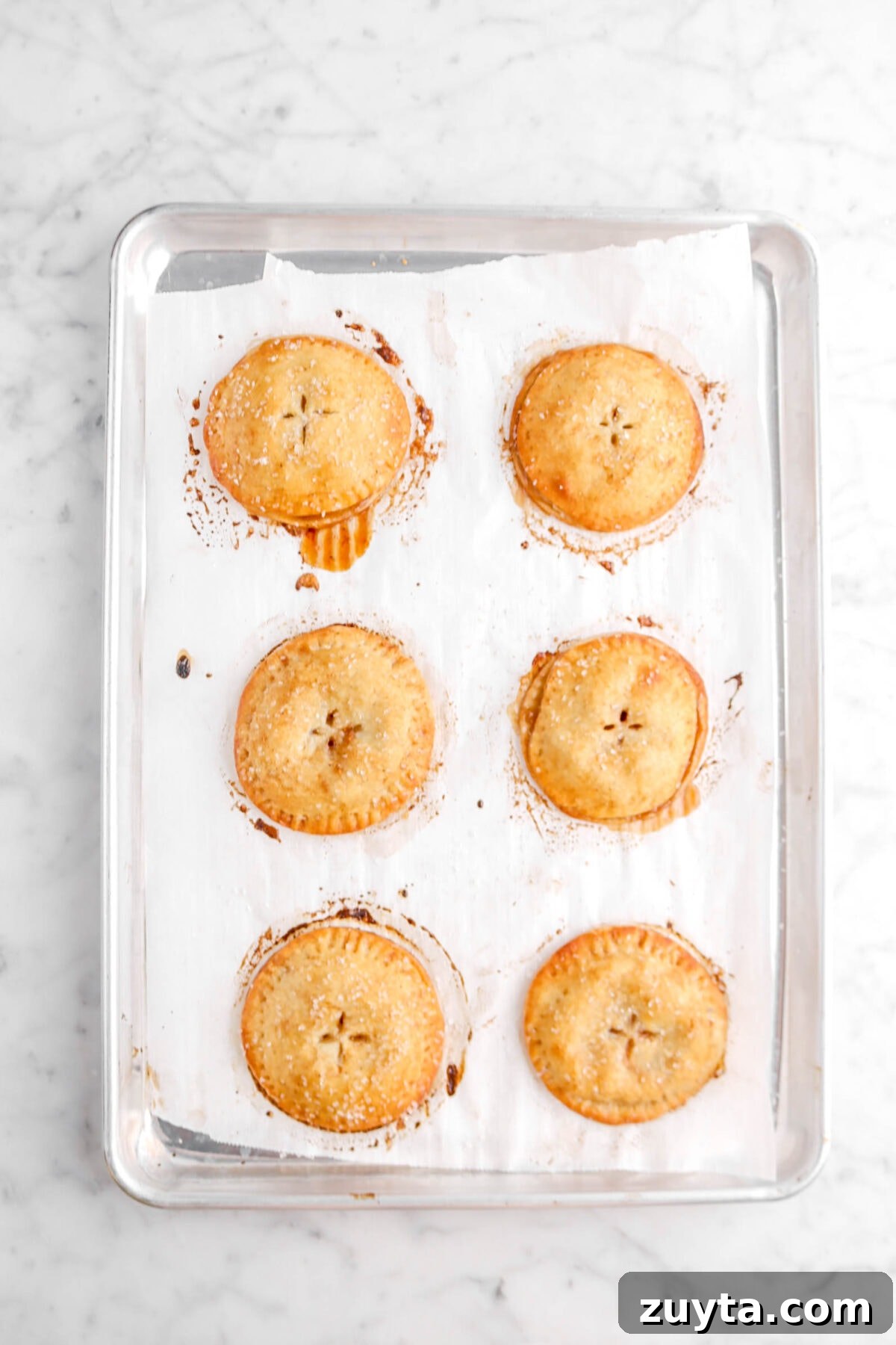 Cinnamon-Spiced Peach Hand Pies Recipe 11 baked hand pies on lined sheet pan