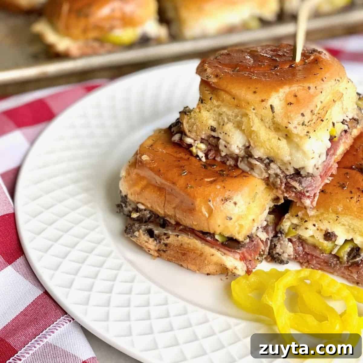 Sheet Pan Dinner Recipes for Quick Weeknight Meals 13 Sliders stacked on a plate.