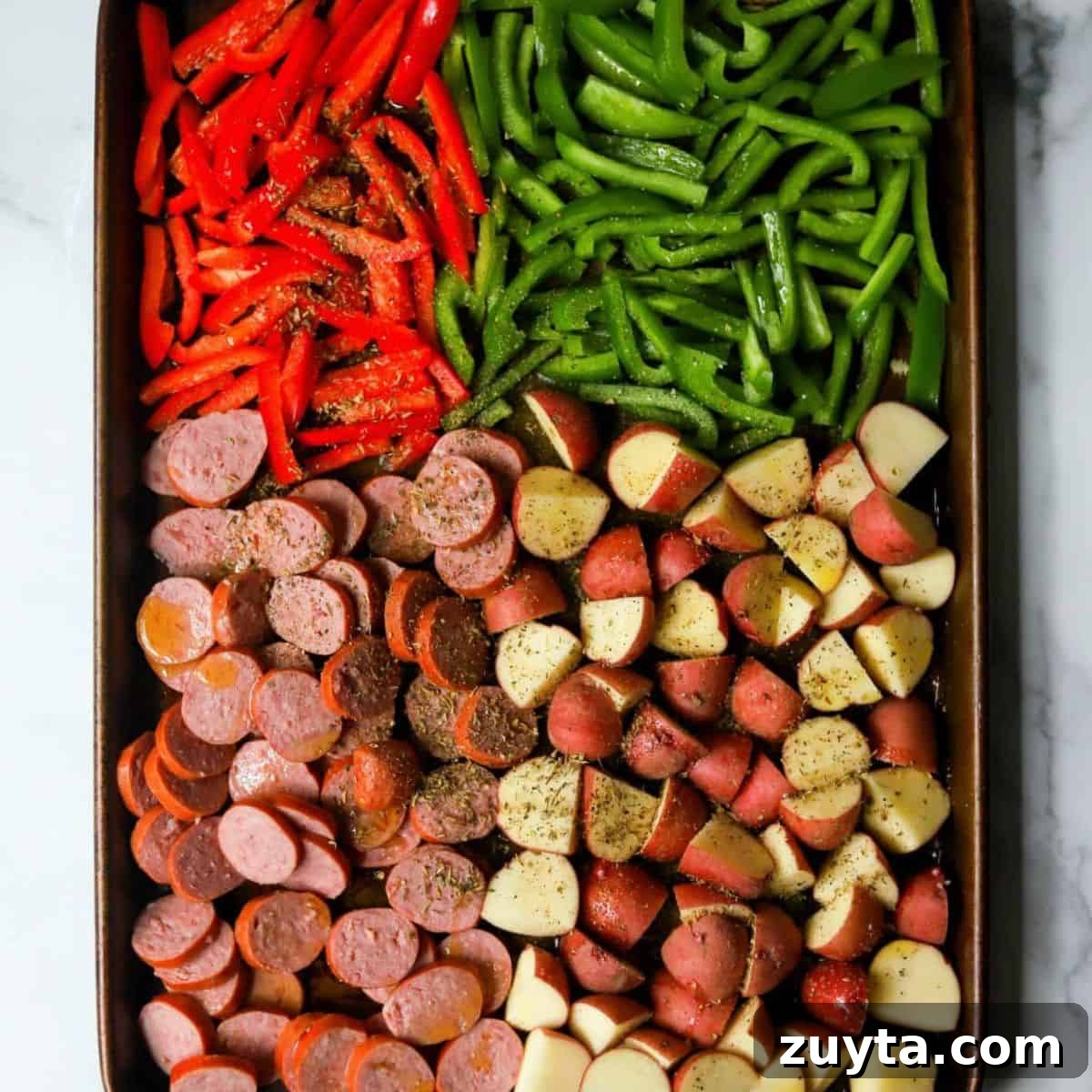 Sheet Pan Dinner Recipes for Quick Weeknight Meals 8 Pan of sausage and potatoes with peppers.