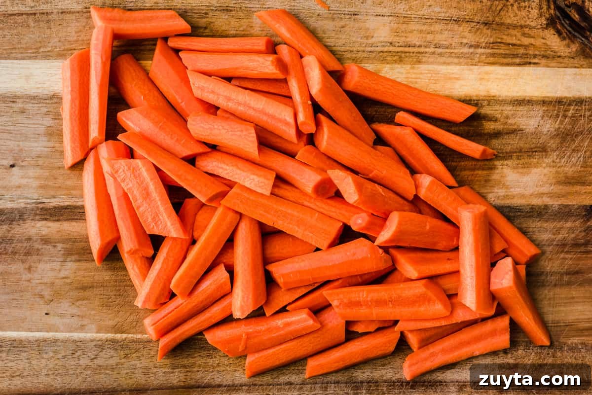 Maple-Roasted Carrots and Dates with Pistachio Pesto 3 Cut carrots on a wooden cutting board.