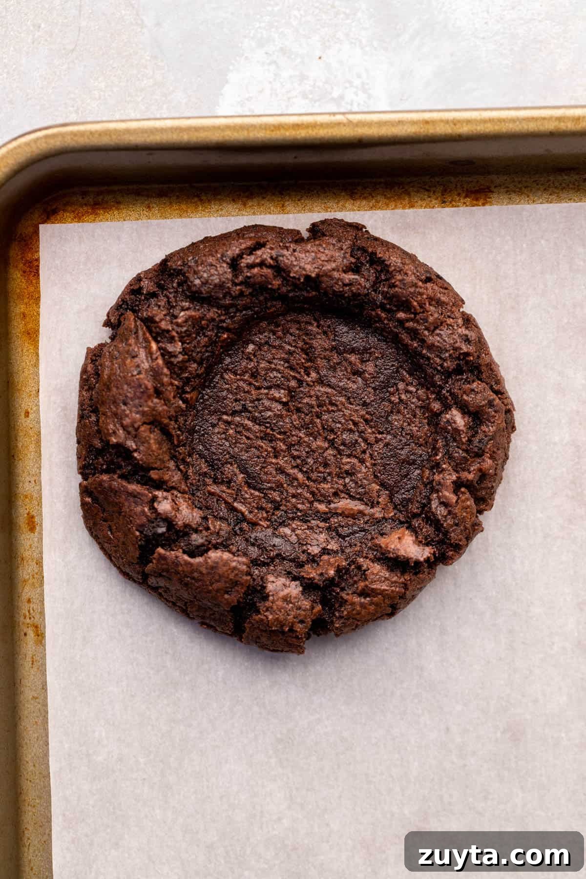 Pressed down cookie on cookie sheet.
