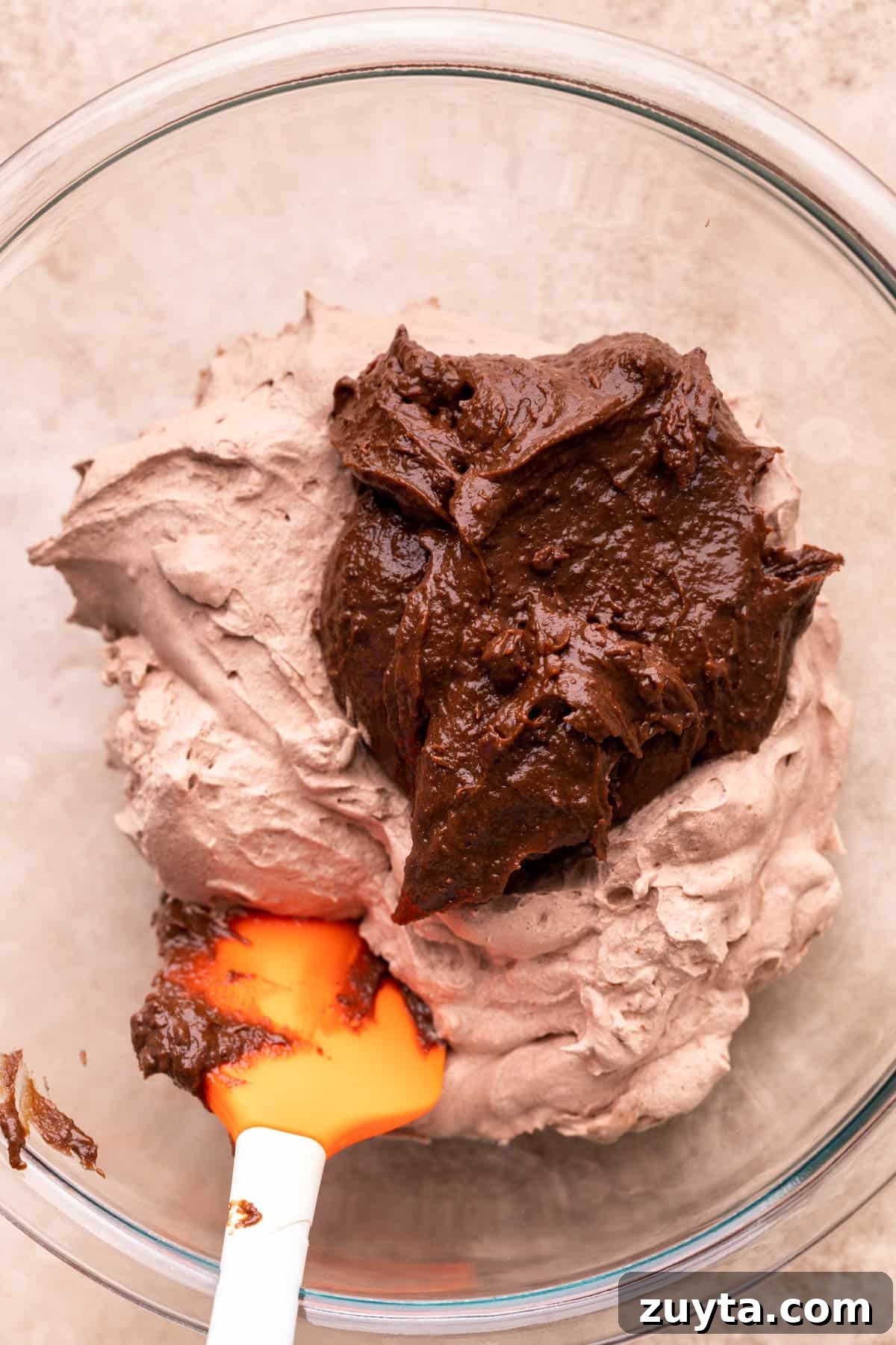 Chocolate pudding on top of chocolate whipped cream.
