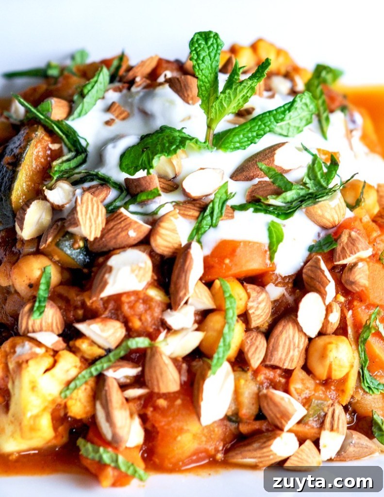 Top down view of Moroccan vegetable stew made with mint, veggies, stews, spices, and dried figs.