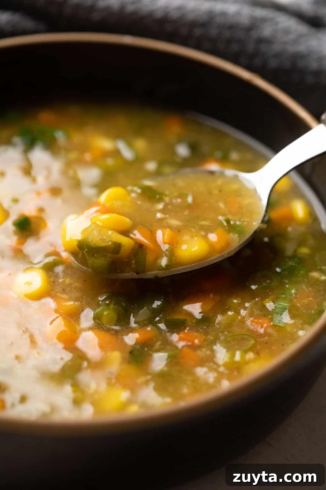 Creamy Vegetarian Sweet Corn Soup Recipe 2 Closeup of a spoon of vegetarian sweet corn soup to show the creaminess and texture of the soup