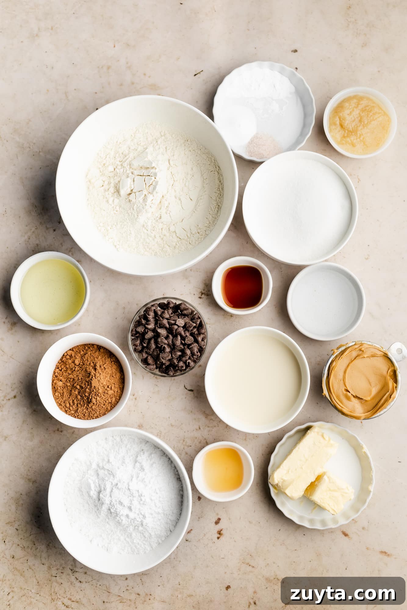 ingredients for chocolate peanut butter cake in individual white bowls.
