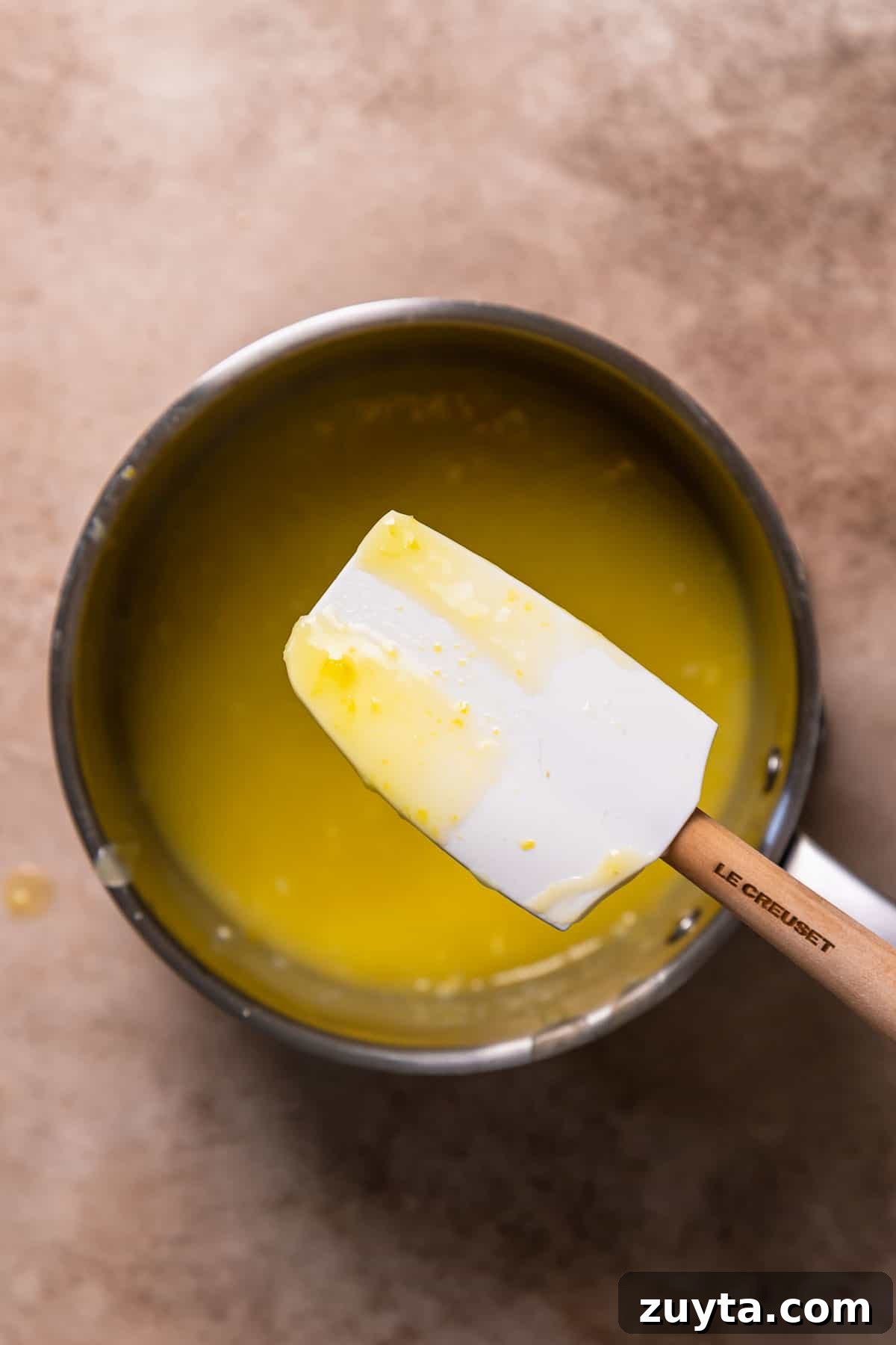 Lemon Curd Recipe: Homemade, Smooth, Zesty 4 A spatula coated in lemon curd to show the thickened texture.