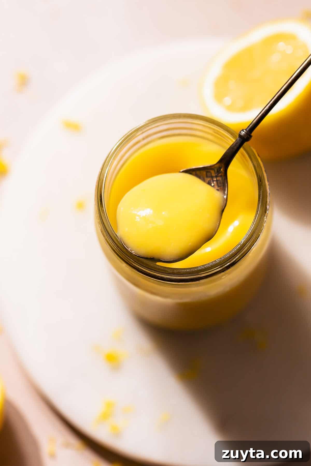 Lemon Curd Recipe: Homemade, Smooth, Zesty 9 Lemon curd on a spoon showing the super creamy texture.