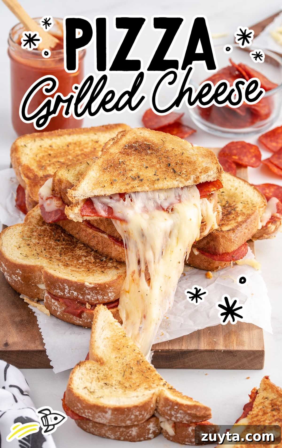 close up shot of grilled cheese sandwiches being pulled apart on a wooden board