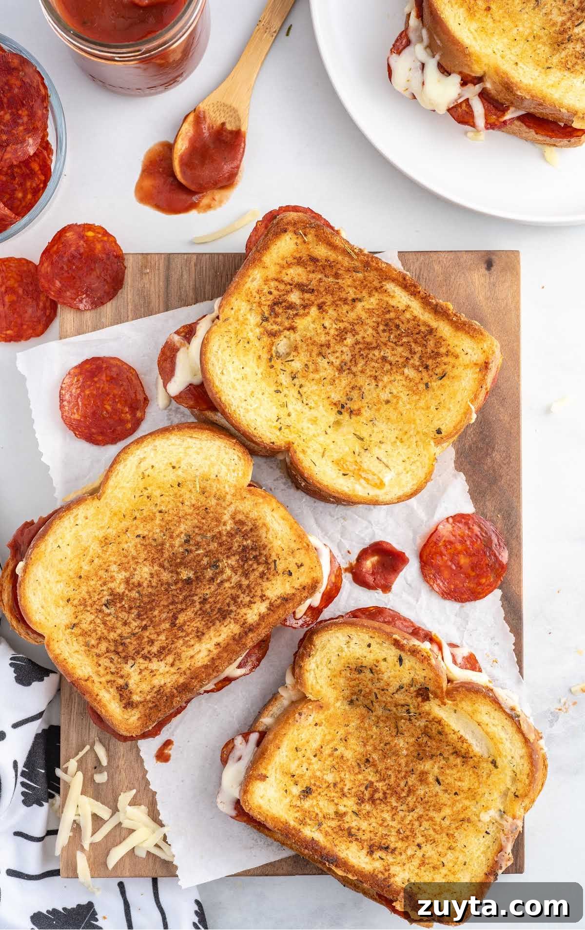 overhead shot of grilled cheese sandwiches on a wooden board