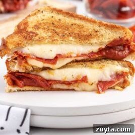 close up shot of slice of grilled cheese sandwiches on a plate