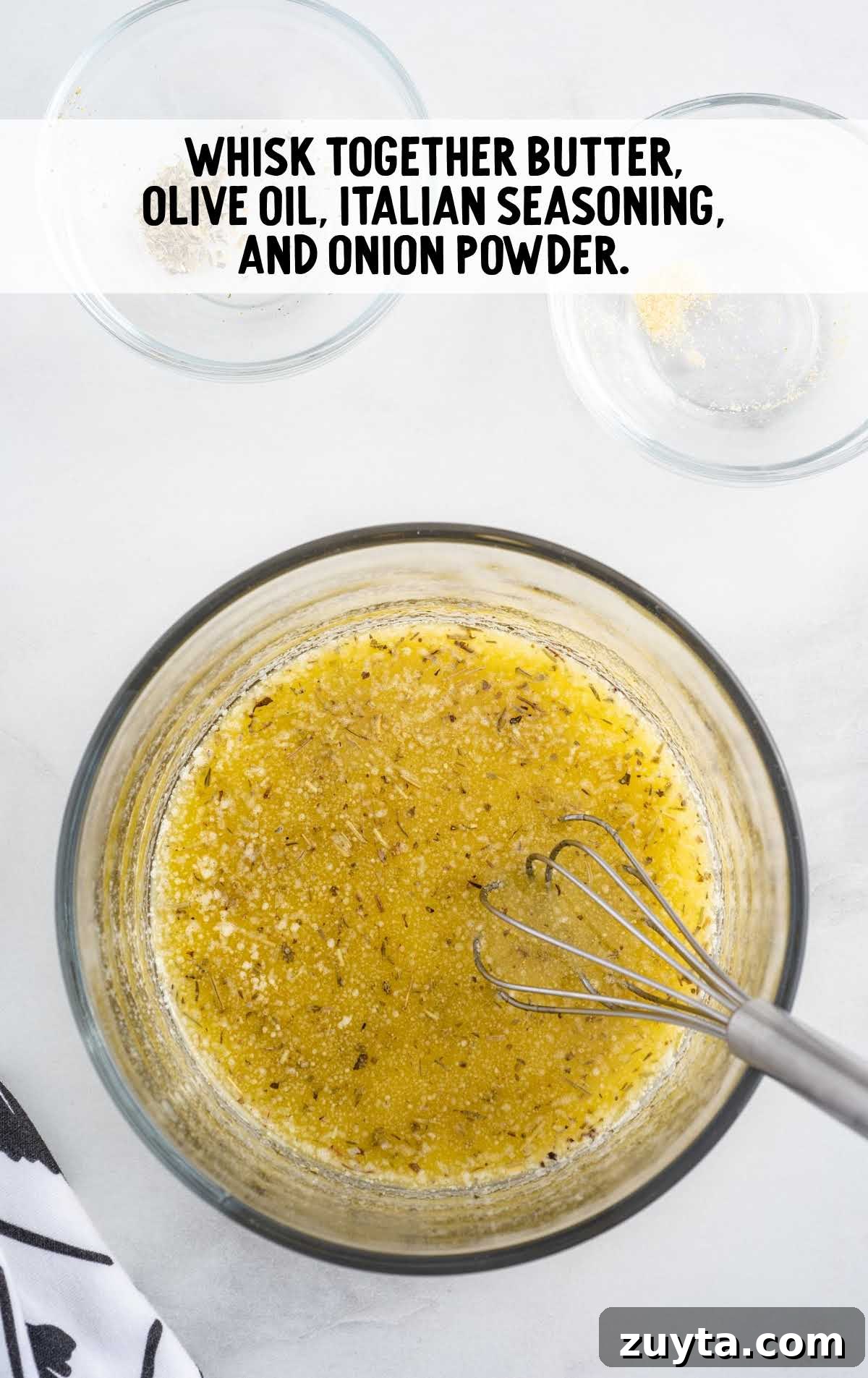 butter, olive oil, and seasonings whisked together in a bowl