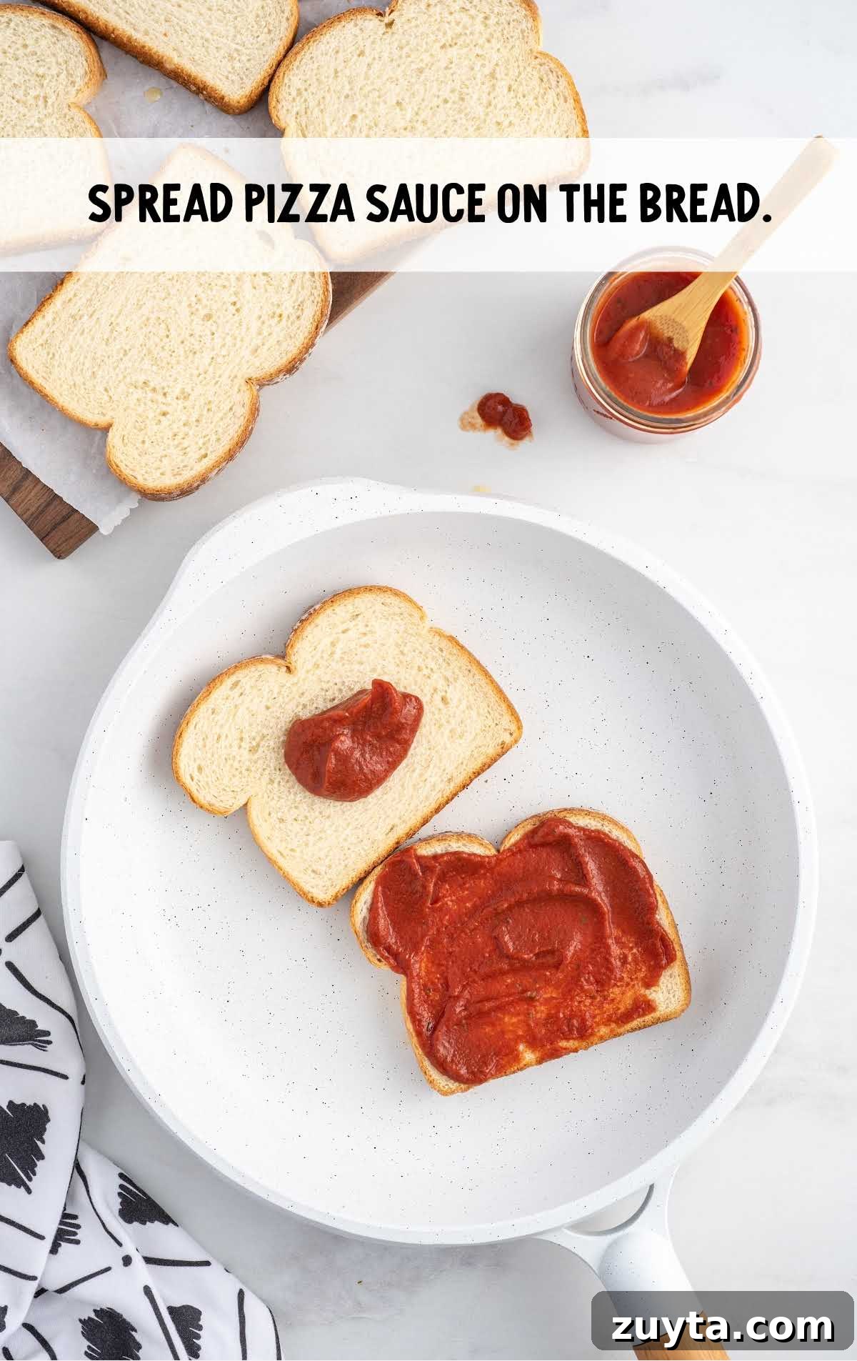 pizza sauce spread on top of the bread