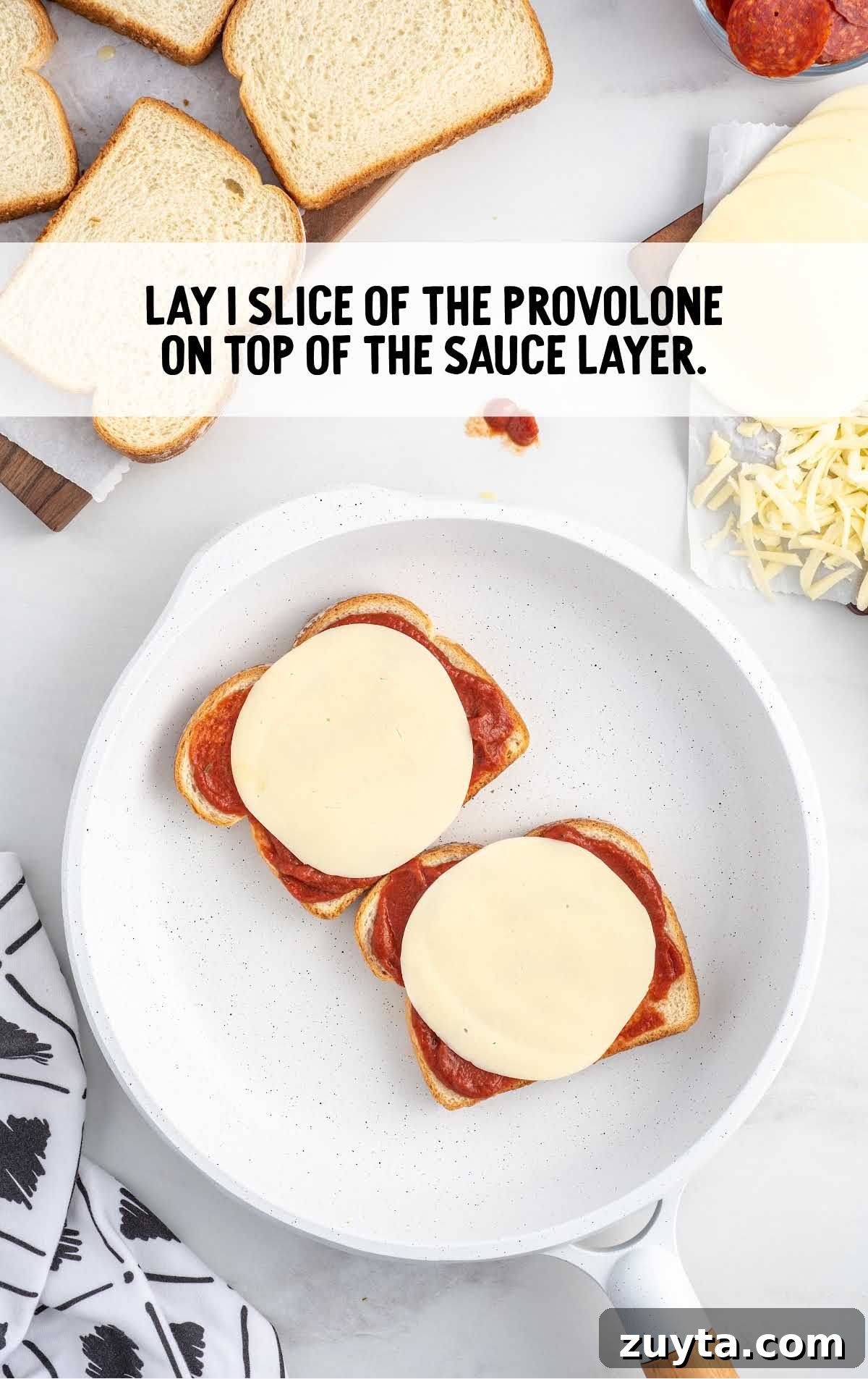 slice of provolone placed on top of the pizza sauce