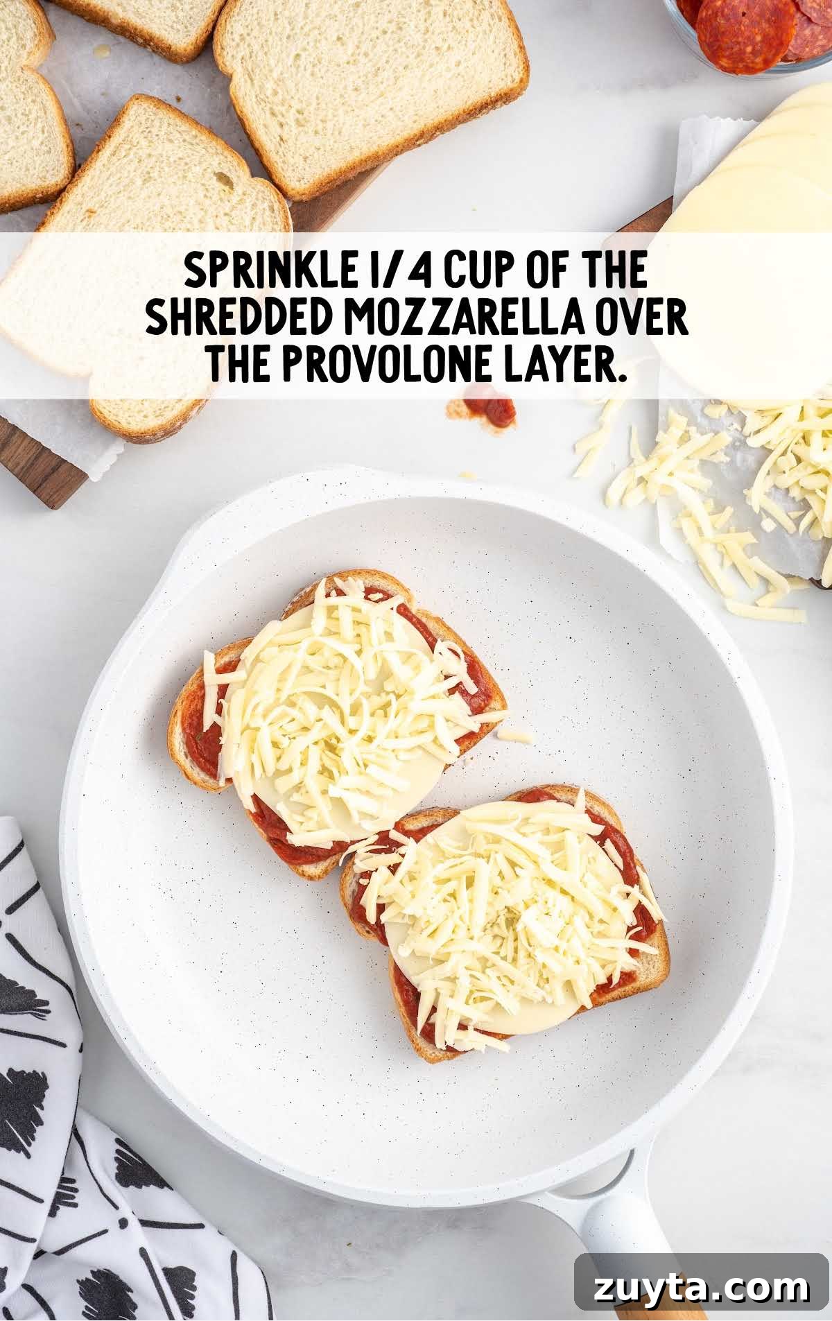 shredded mozzarella cheese placed on top of the provolone