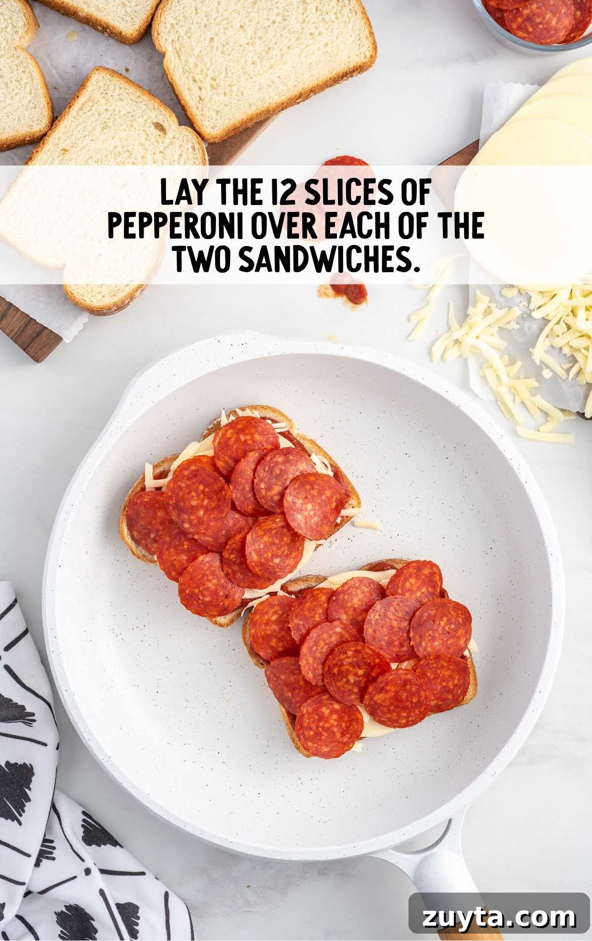 slices of pepperoni placed on top of the shredded mozzarella cheese
