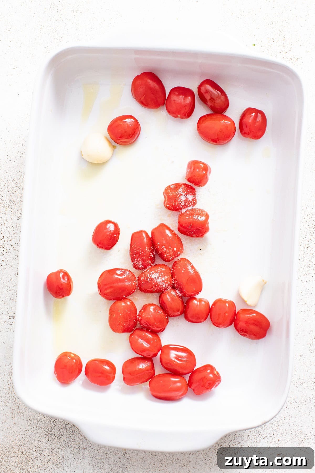 Creamy Boursin Orzo Bake Recipe 4 Tomatoes and garlic in a casserole dish.