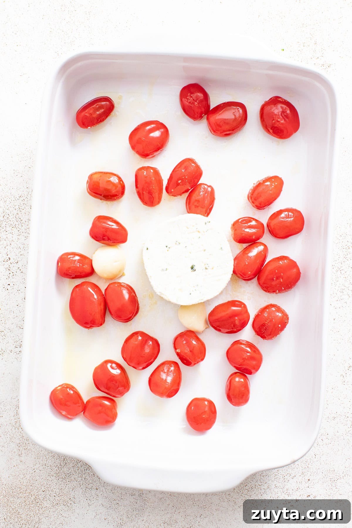 Creamy Boursin Orzo Bake Recipe 5 Boursin cheese, garlic, and tomatoes in a casserole dish.