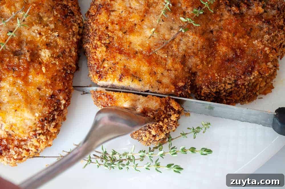 Foolproof Pork Chop Recipes for Juicy Weeknight Dinners 12 A knife cutting into a crispy pork chop.