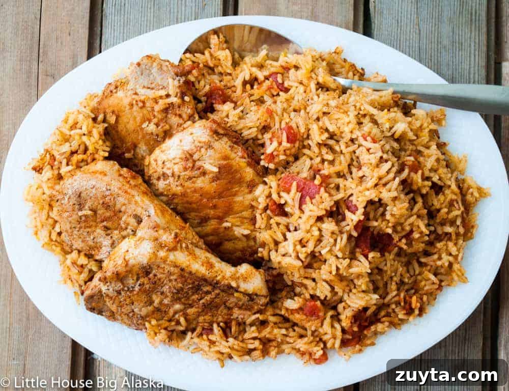 Foolproof Pork Chop Recipes for Juicy Weeknight Dinners 13 Spanish Rice and pork chops on a platter.