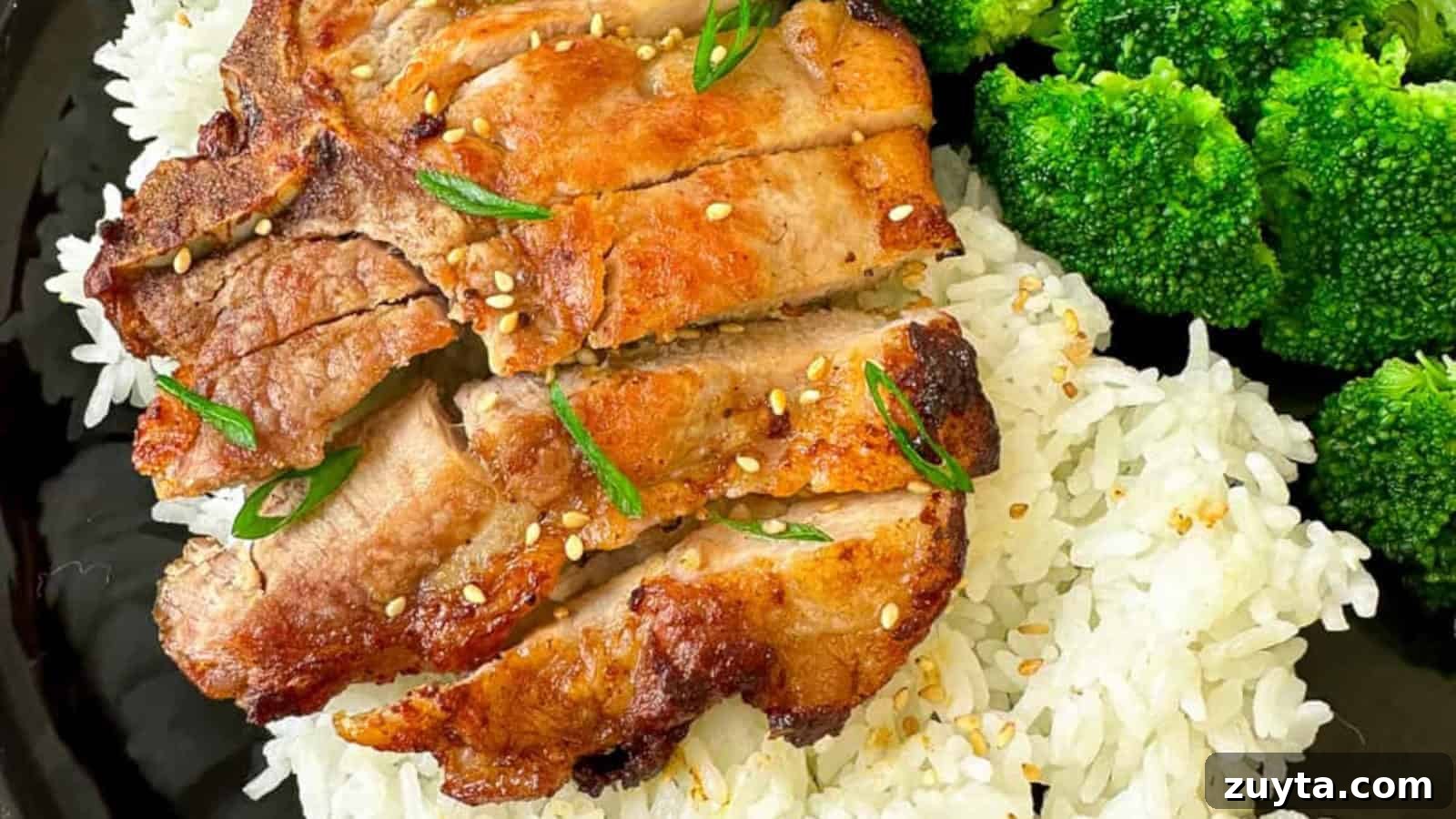 Foolproof Pork Chop Recipes for Juicy Weeknight Dinners 4 Grilled pork slices on white rice, garnished with sesame seeds and green herbs, served with broccoli florets.
