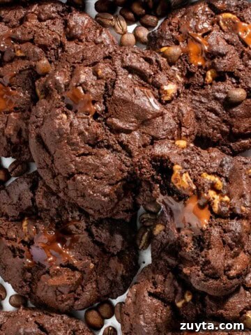 Chocolate chip coffee cookies on a white tray surrounded by coffee beans.