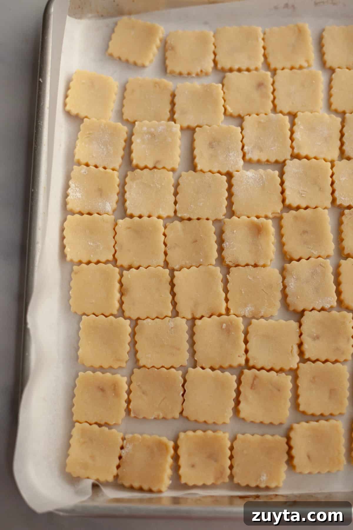 Double-Ginger Shortbread Cookies Recipe 8 Unbaked ginger cookies on a parchment lined baking sheet.