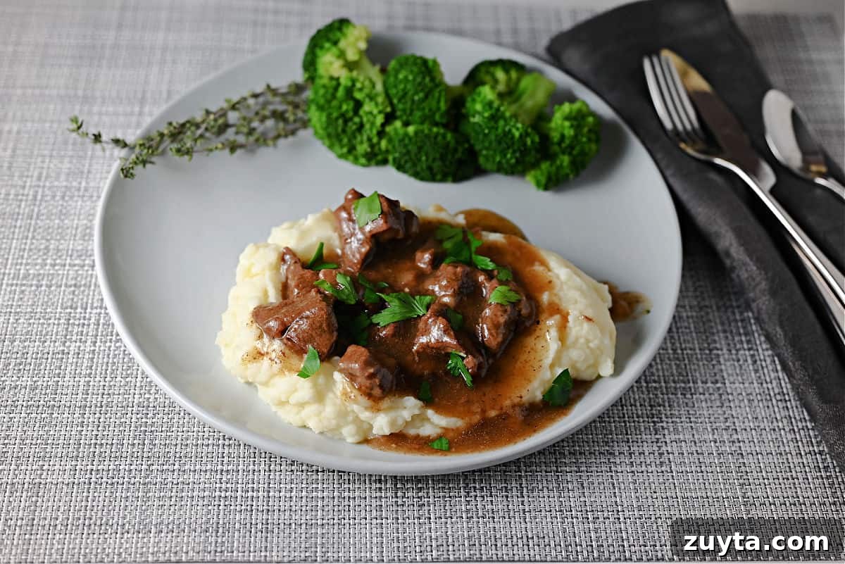 Beef tips made in the Instant Pot and served on mashed potatoes.