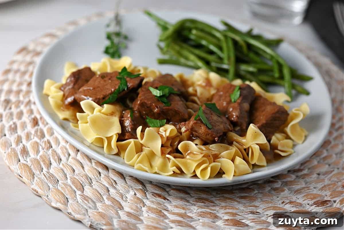 Instant Pot Beef tips and gravy on egg noodles.