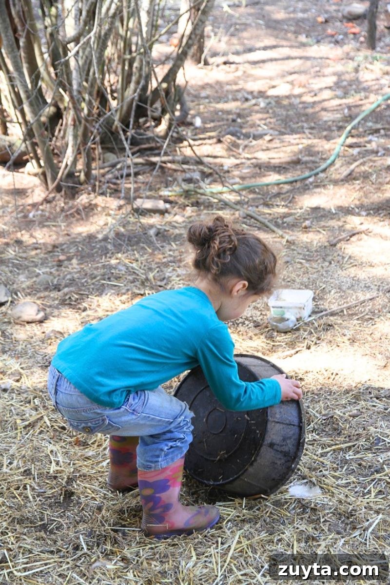 7 Eye-Opening Lessons From Living Without the Internet 5 A little girl emptying a chicken waterer in the middle of a chicken pen.