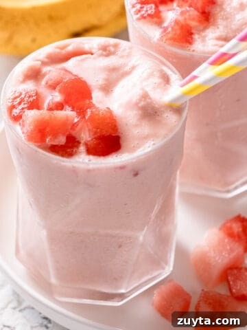two banana watermelon smoothies on white plate