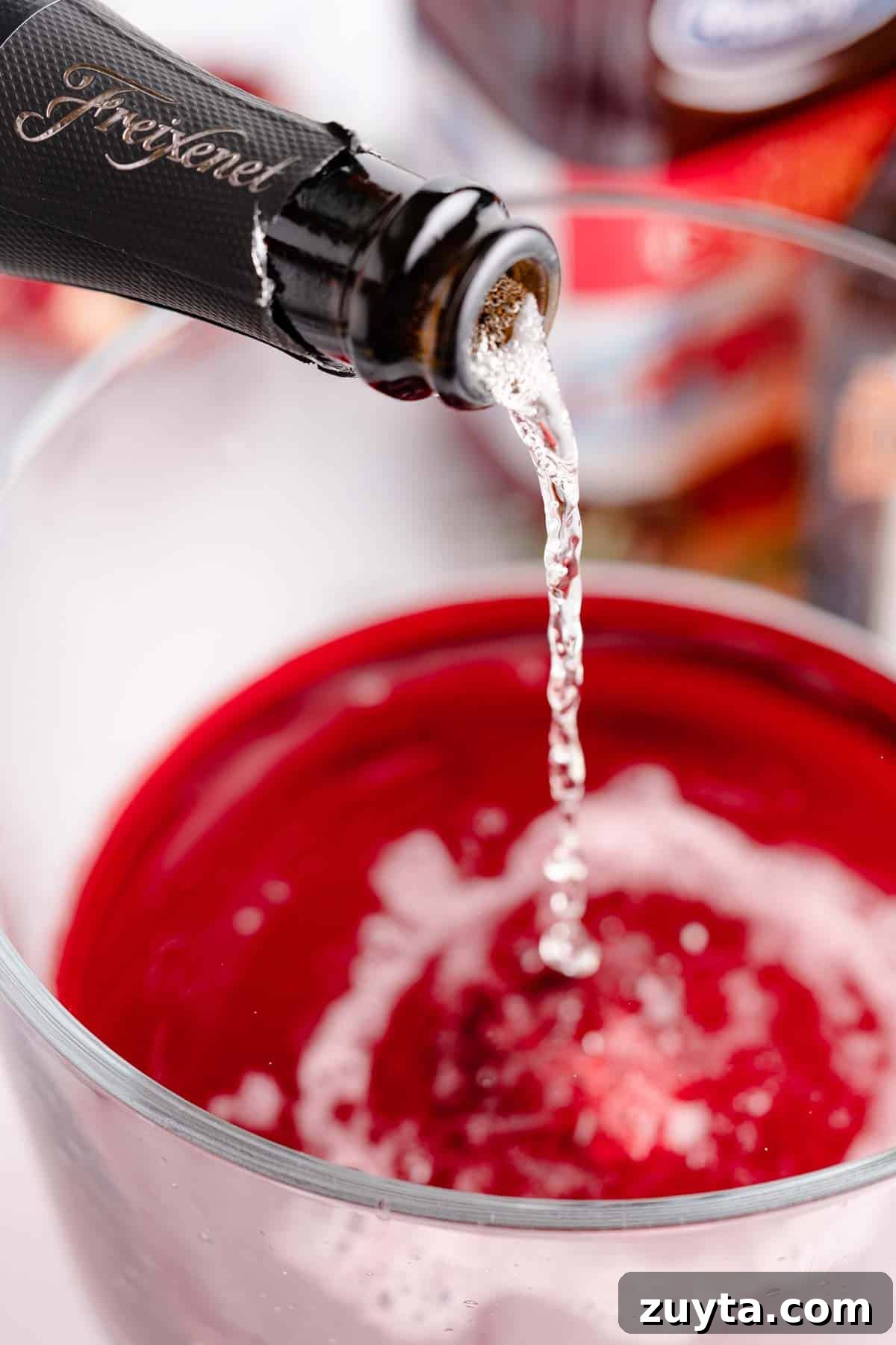 Sparkling Pomegranate Cranberry Punch Recipe 6 sparkling wine being poured into punch bowl