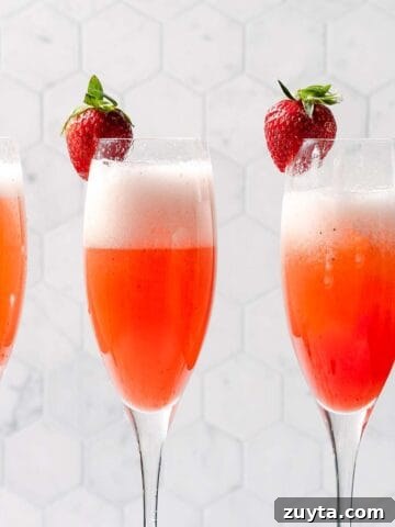 three glasses of strawberry mimosas