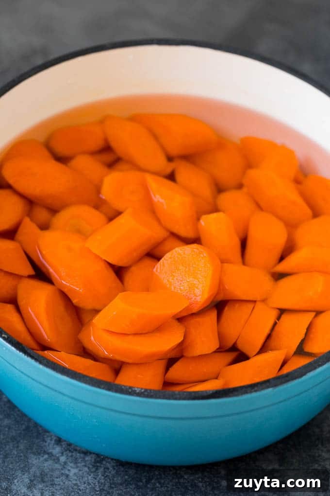 Sliced carrots in a pot of water. Sliced carrots in a pot of water.