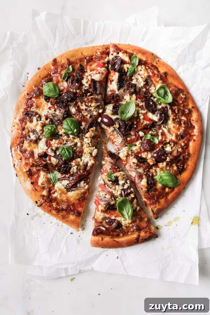 mediterranean pizza with a slice cut out