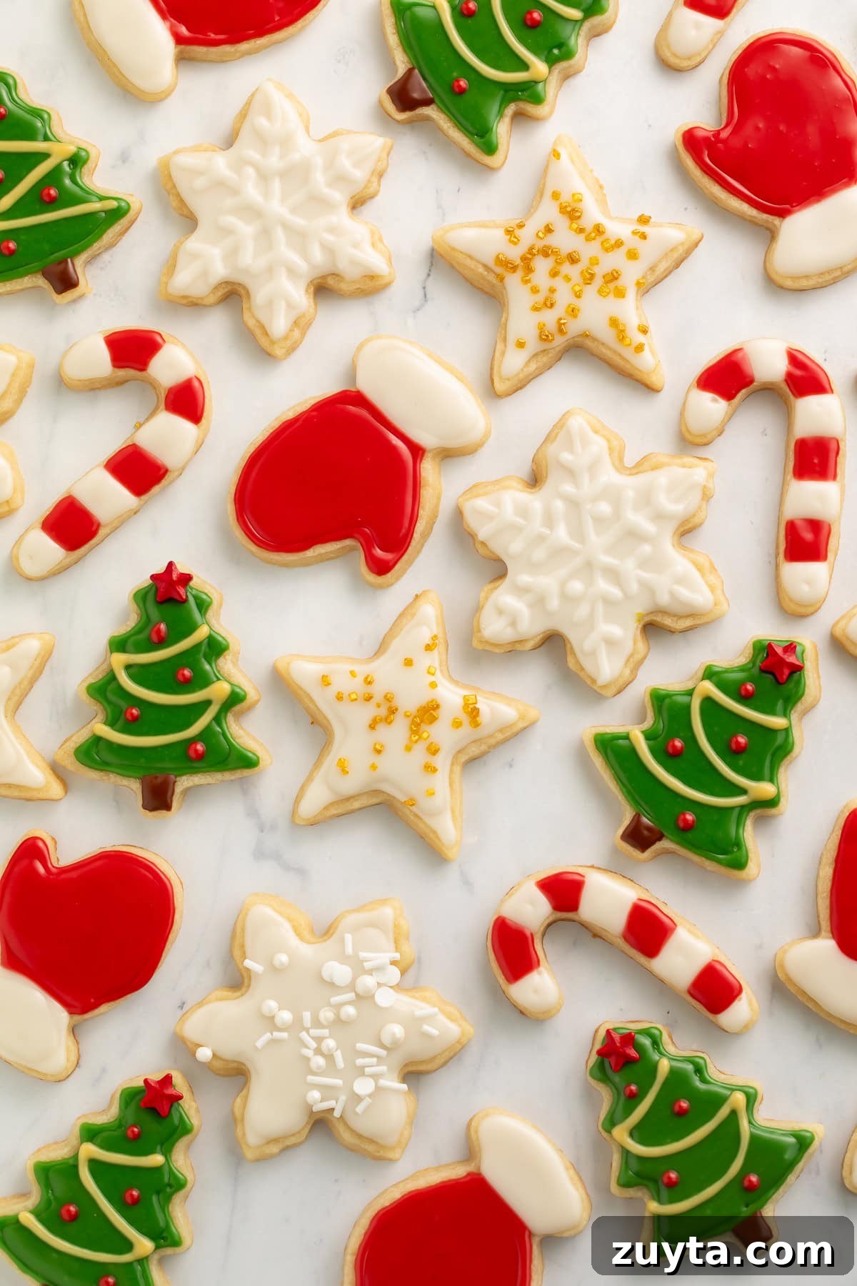 Vegan Christmas Cookie Recipes for the Holidays 2 Various vegan decorated Christmas cookies on a white marble background.
