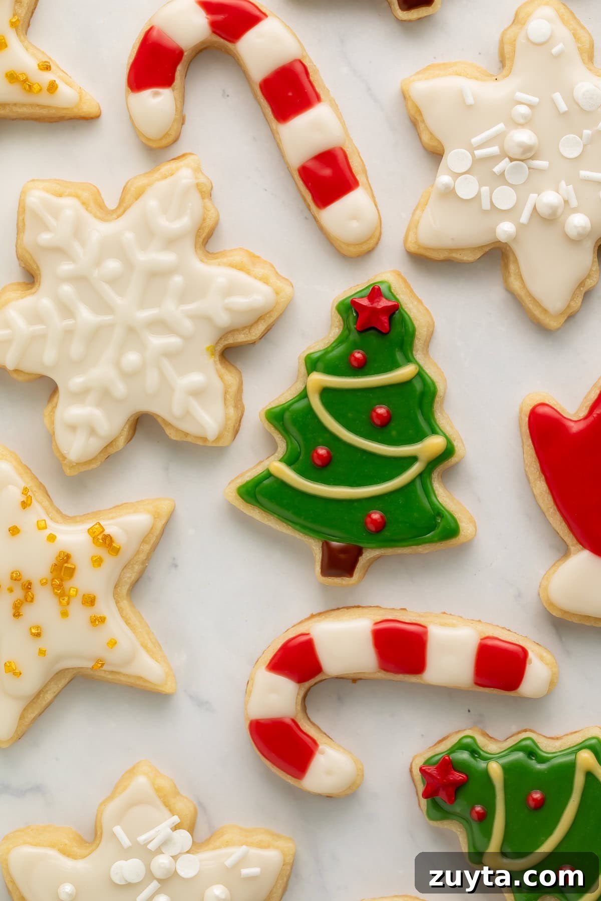 Vegan Christmas Cookie Recipes for the Holidays 3 Close up of Christmas cookies with green, white, red, and yellow frosting.