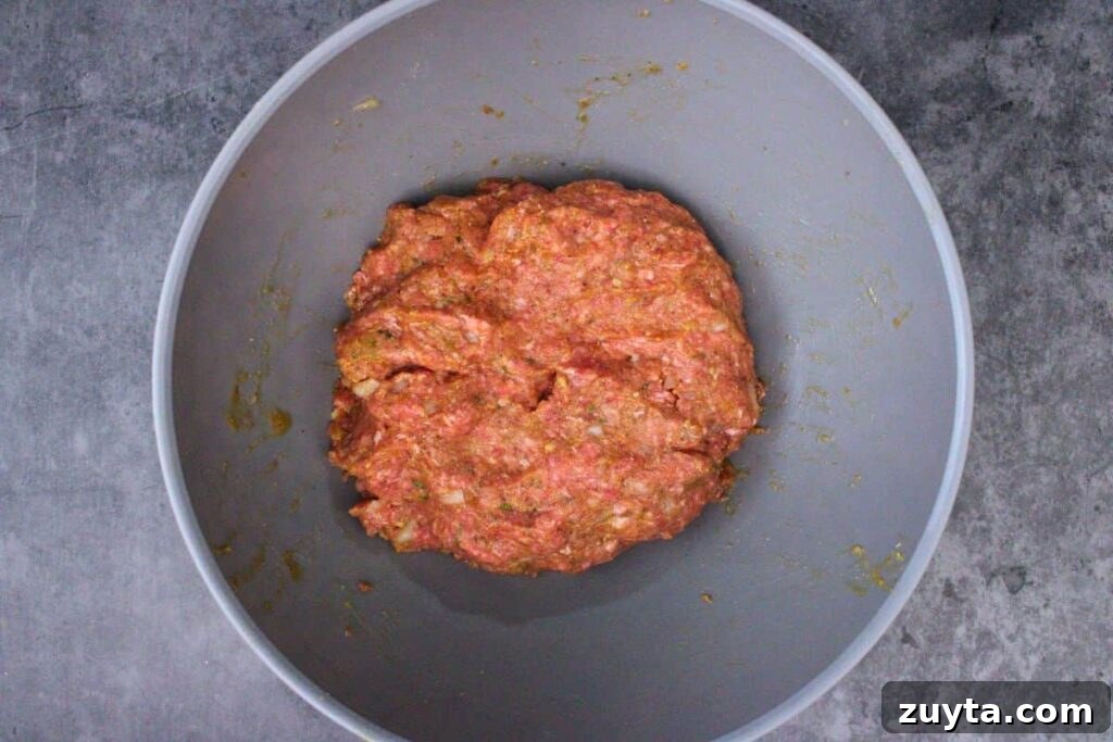 combine meatloaf ingredients except crescent dough and eyeballs in a large bowl