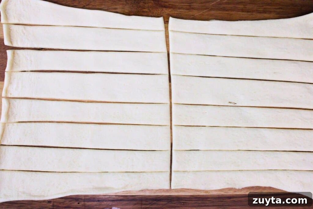 roll out crescent dough and cut into even strips