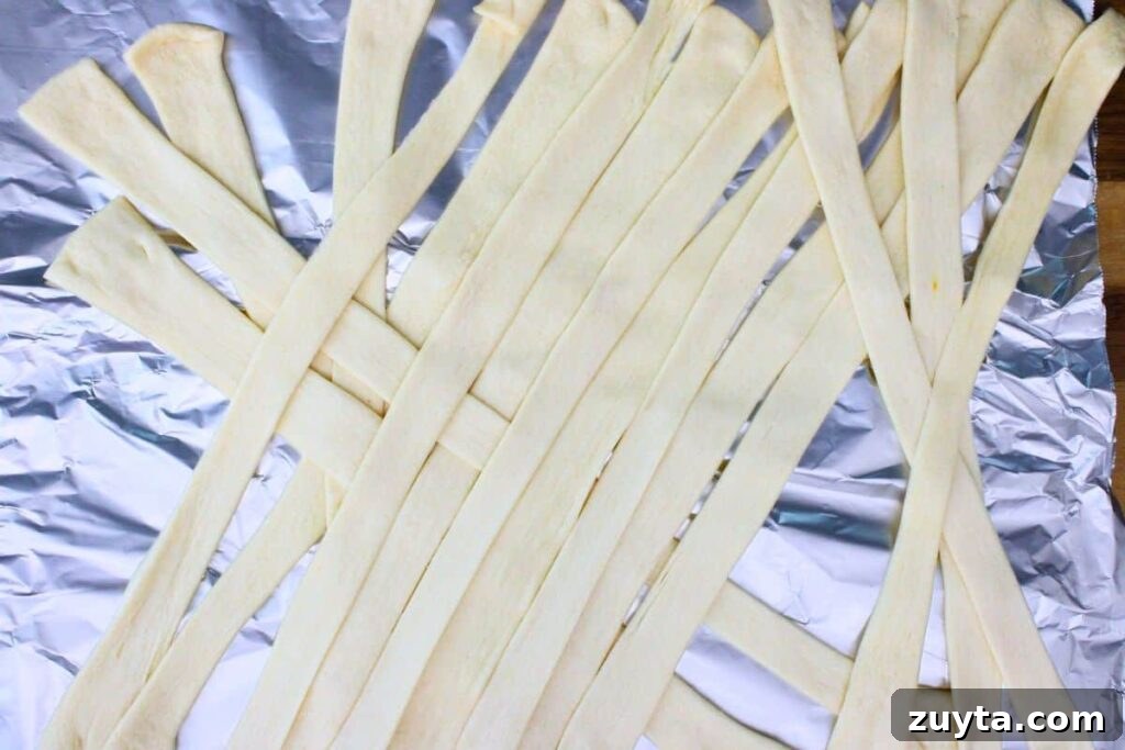 lay crescent dough in crossing strips to mimic mummy pattern