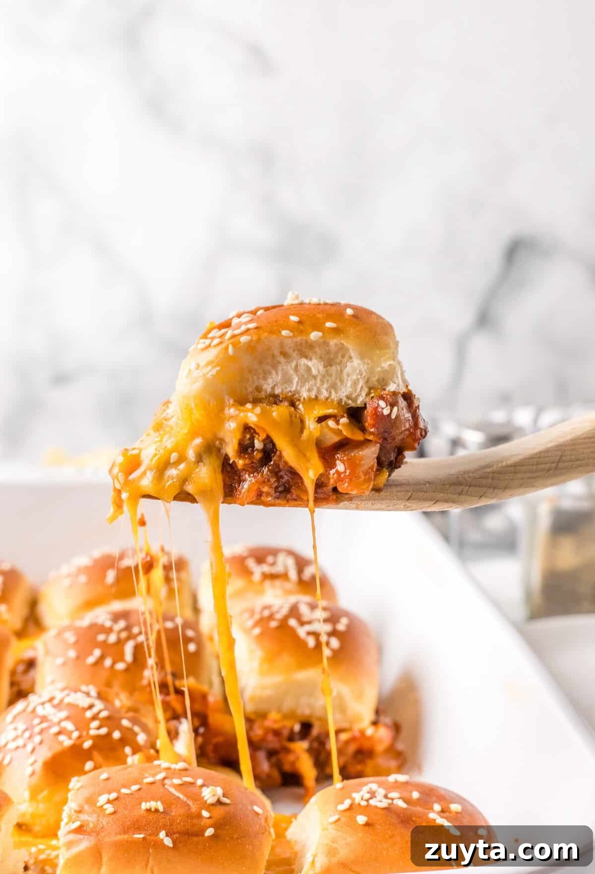 Sloppy Joe Sliders Recipe for Game Day and Parties 2 A cheesy sloppy joe slider being served.