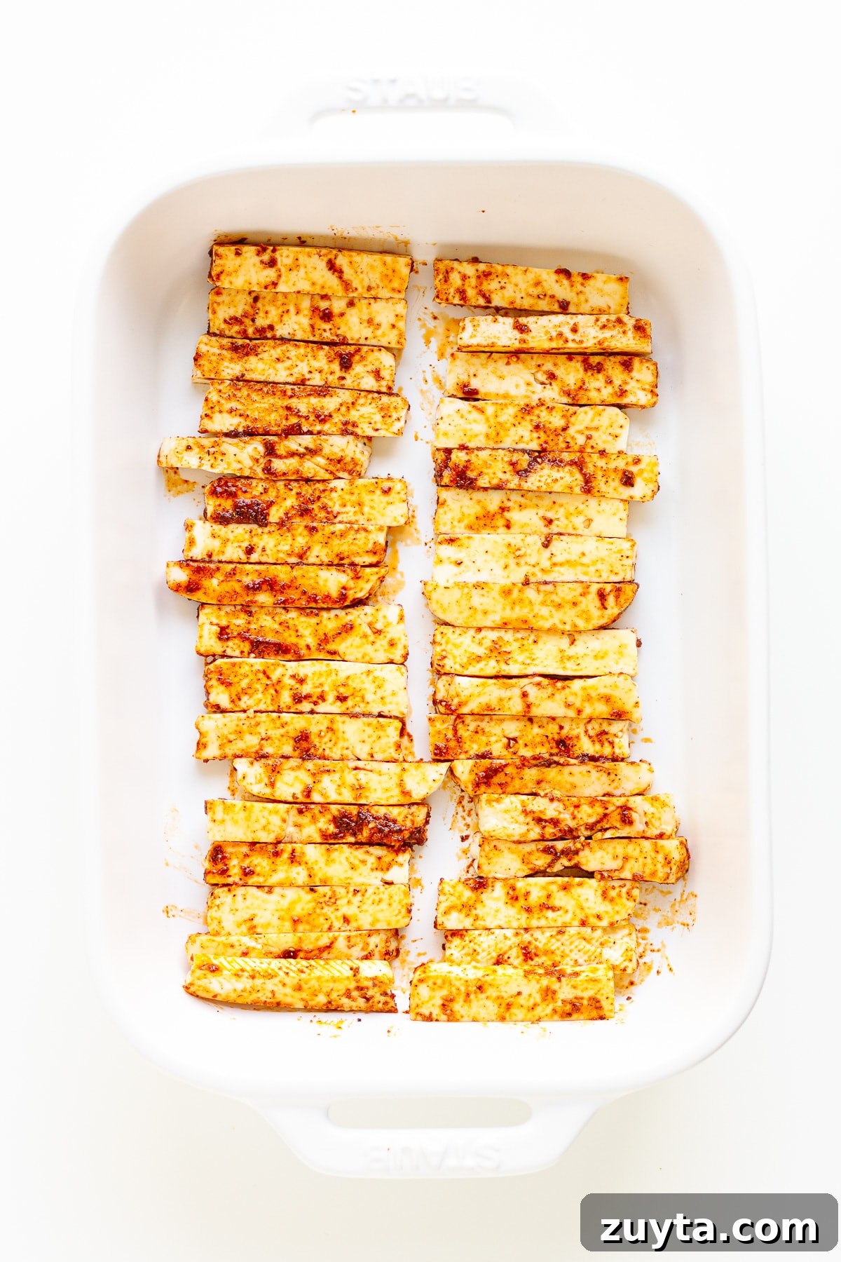 Grilled Halloumi Fajitas with Peppers and Lime 6 Seasoned halloumi strips in a white casserole dish.