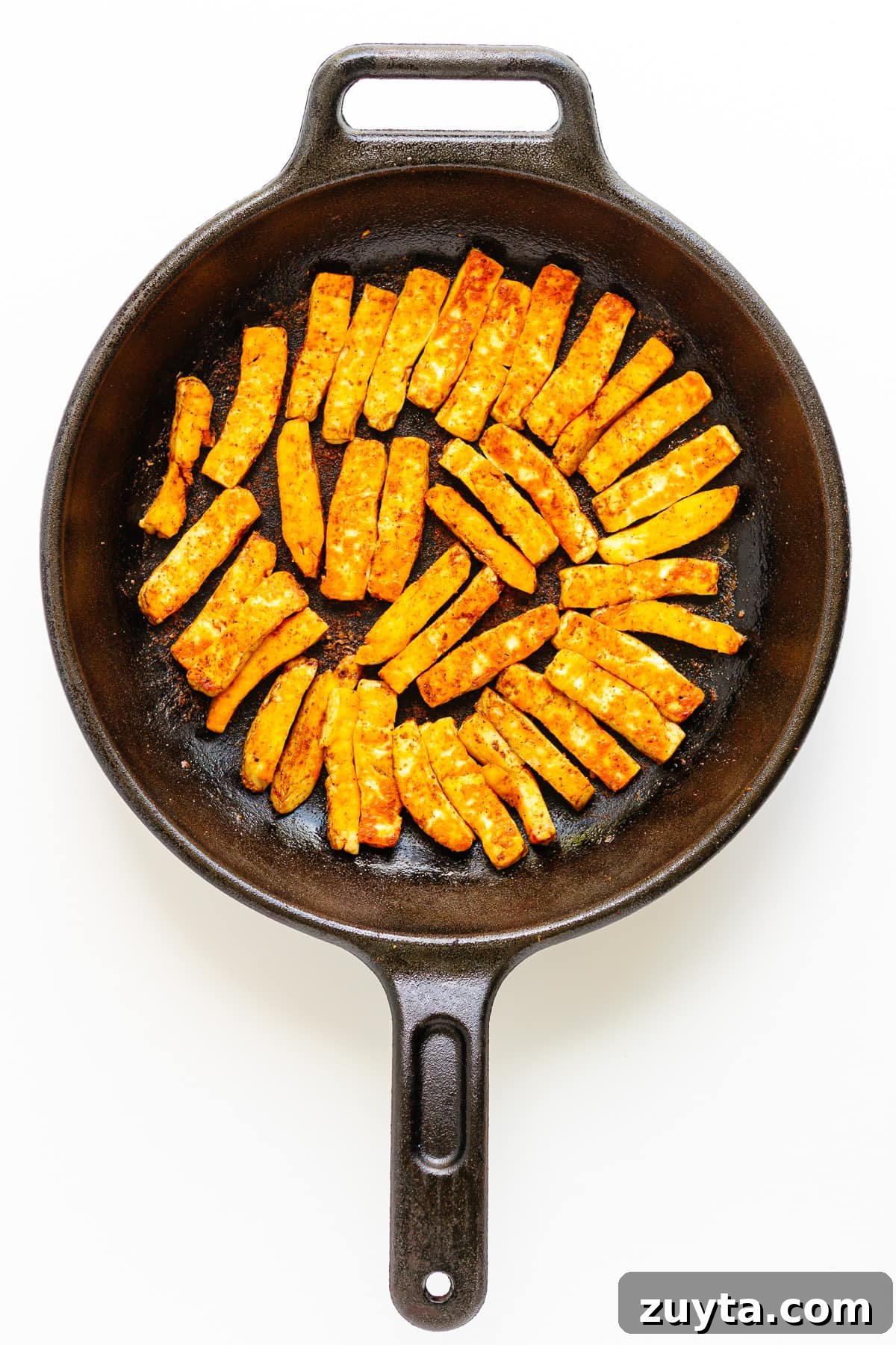 Grilled Halloumi Fajitas with Peppers and Lime 8 Fried halloumi strips in a cast iron skillet.
